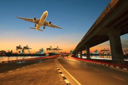 road ,land bridge run into ship port and commercial cargo plane flying above use for land ,air and vessel transport industry business